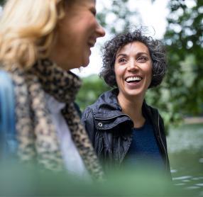 Woman smiling with friend in forest