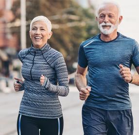 Senior man and woman jogging